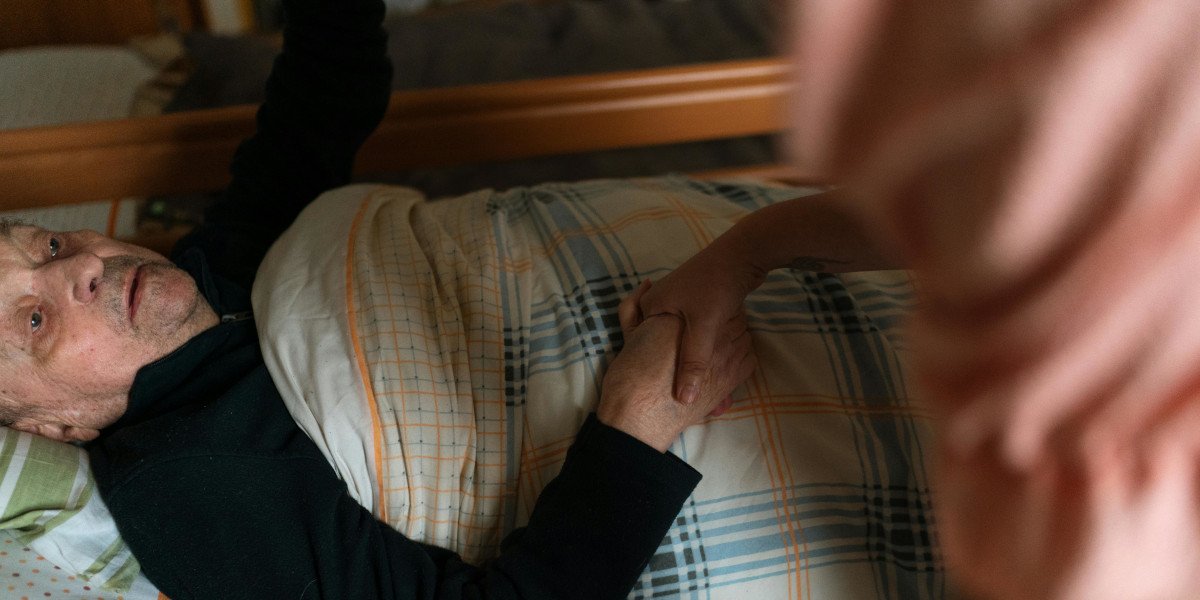 Professional elderly care nurse with senior patient